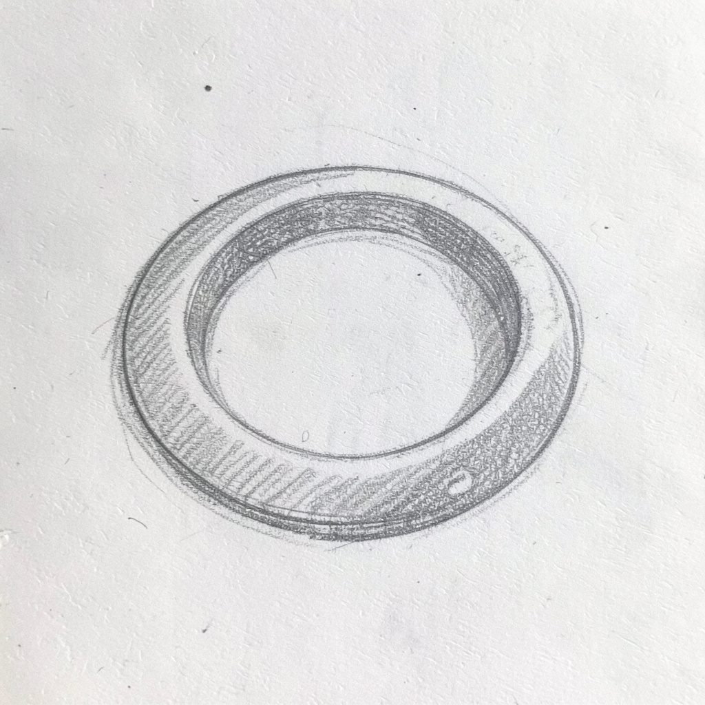 Circular badge with a small leaf motif drawn in mustard and mossy green pencil